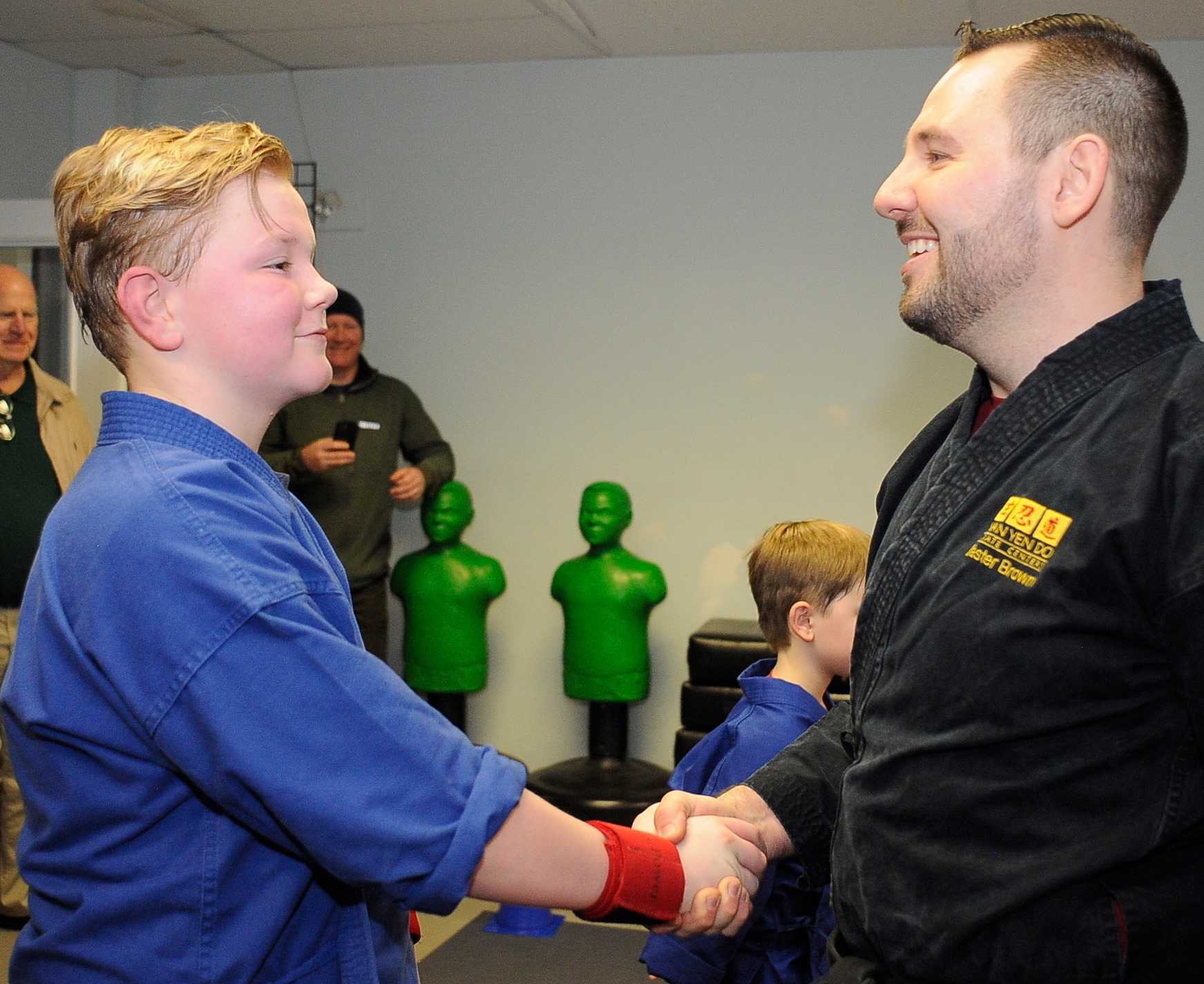 Master Brown handshake with student
